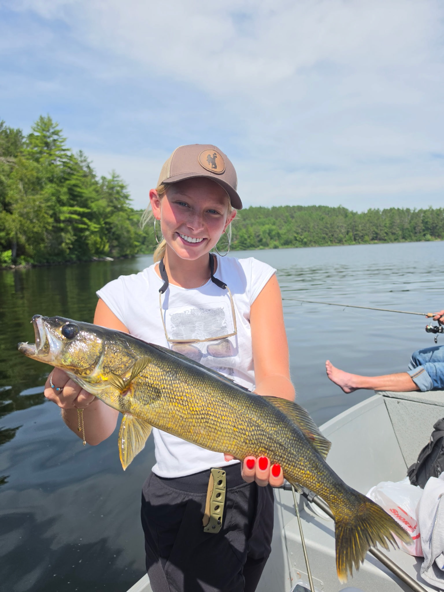 Guest holding a golden walleye