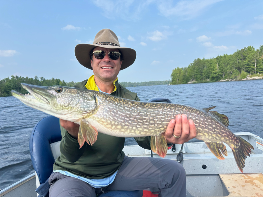 Guest holding a northern pike