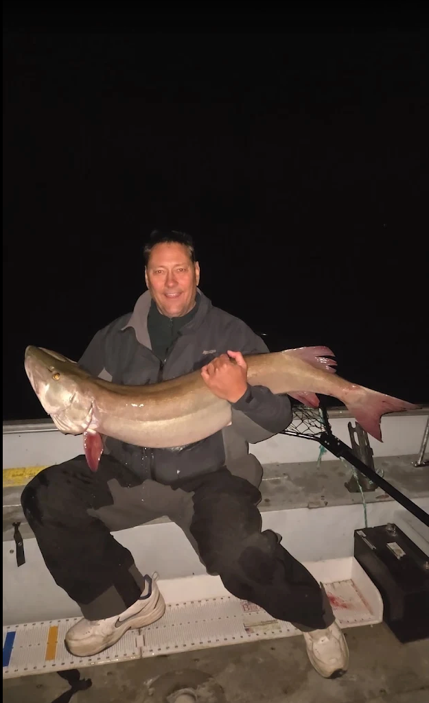Tom Rozman holding a big muskie caught at night