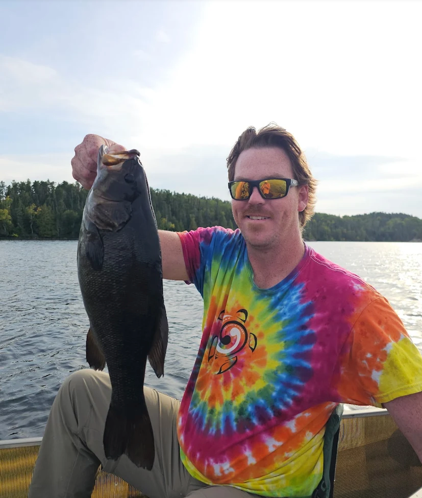 Guest with a big smallmouth bass on a four-day Bass Lake trip